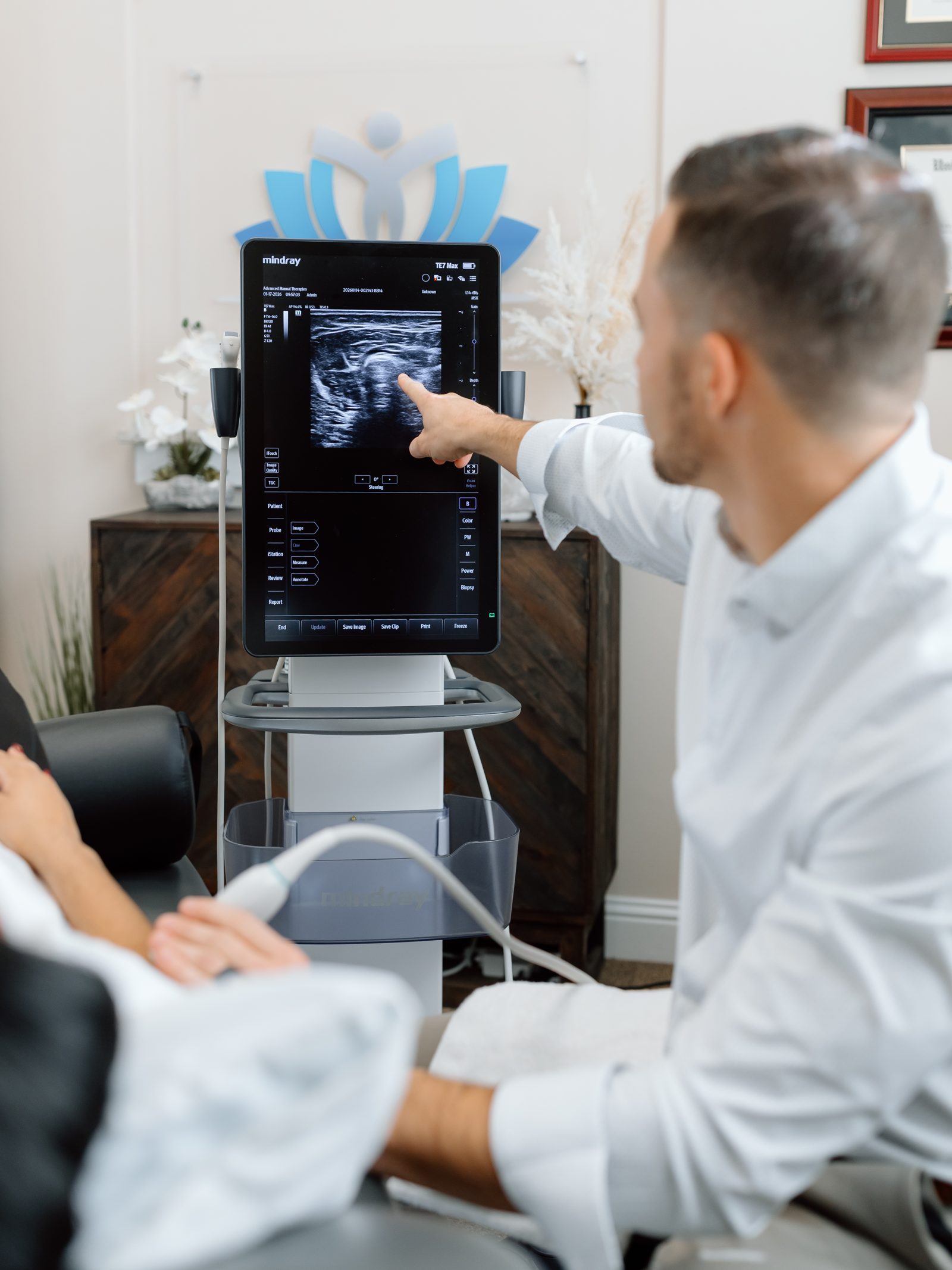 Dr. Grant Smith performing musculoskeletal ultrasound imaging in the clinic